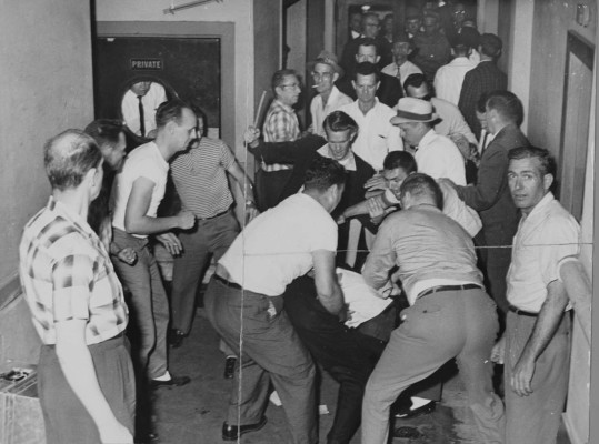 A mob of racists beats Freedom Riders in Birmingham, Alabama, May 14, 1961.