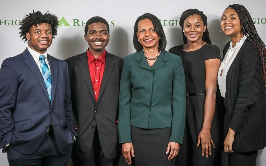 Group picture of Condoleezza Rice with a group of Birmingham city high schoolers in front of a Regions Bank backdrop