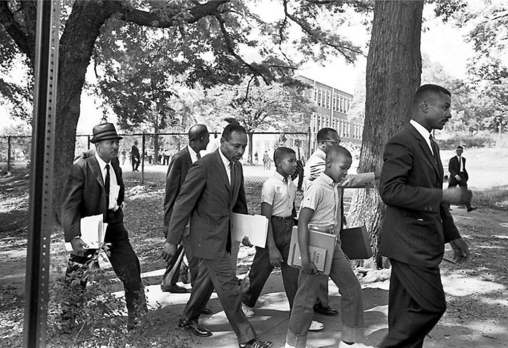 Fred Shuttlesworth, Dwight Armstrong (age 11), Floyd Armstrong (age 10), James Armstrong, Birmingham attorney Oscar Adams, Jr., and NAACP lawyer Constance Motley leaving Graymont Elementary School after the boys were denied registration, September 9, 1963