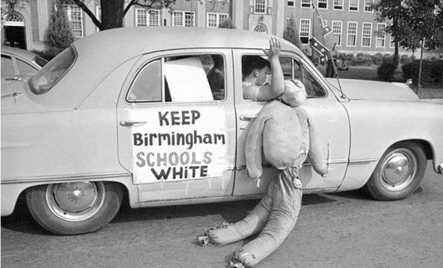 Dummy dragged in effigy past Birmingham's West End High School, September 1963