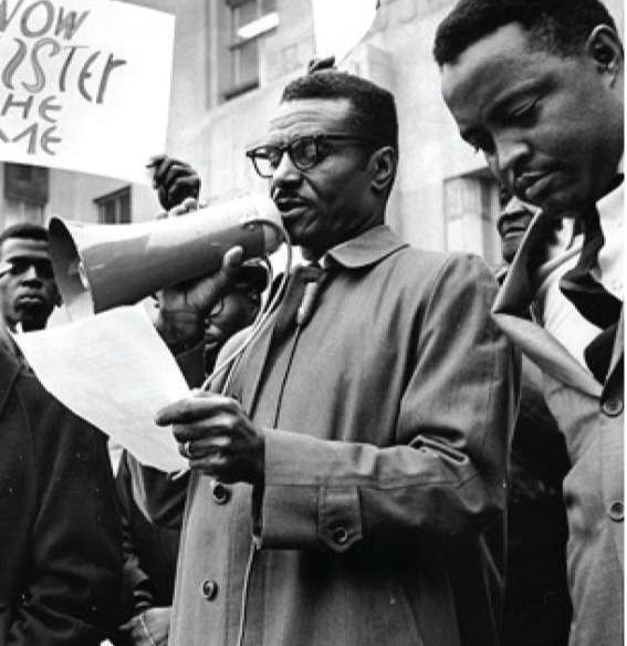 Fred Shuttlesworth reading an announcement to an audience outside a building