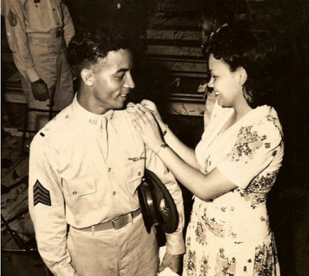 Mildred Hemmons Carter pinning Herbert Carter's rank on his uniform at a promotion ceremony