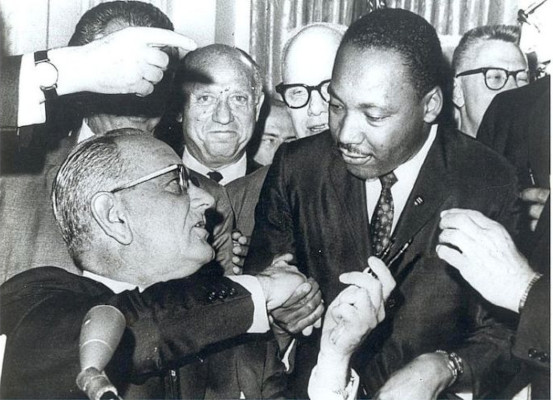 President Lyndon Johnson shakes hands with Rev. Martin Luther King Jr. after signing the Civil Rights Act of 1964.