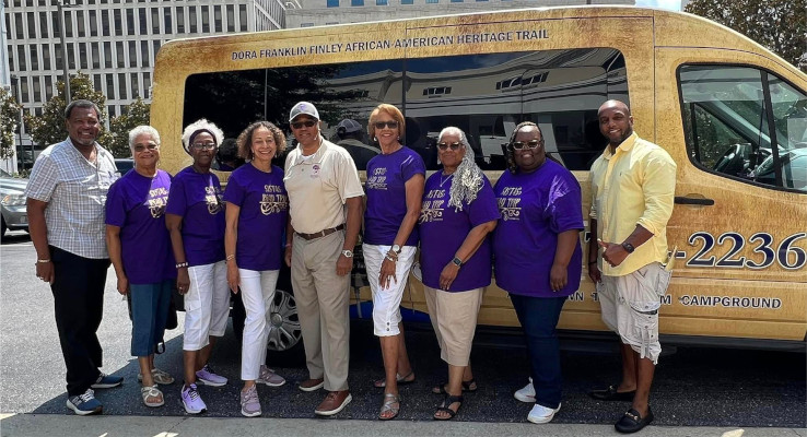 Members of the “Sistas Road Trip” standing in front of the Dora Franklin Finley African American Heritage Tour bus