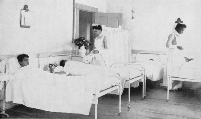 Boys ward, John A. Andrew Memorial Hospital; two nurses attending to boys laying in hospital beds