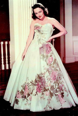 Olivia de Havilland wearing a hand-painted floral Ann Lowe original design