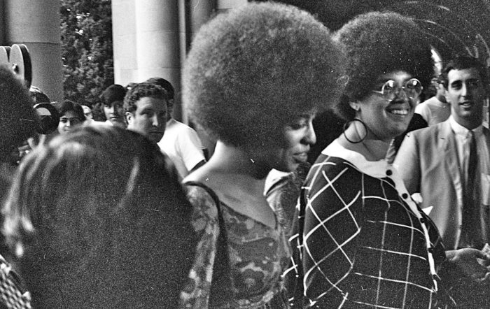 Angela Davis enters Royce Hall with Kendra Alexander at UCLA for her first lecture, October 1969.