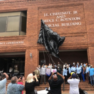 Group of people at the unveiling ceremony for the J.L. Chestnut, Jr. and Bruce C. Boynton Judicial Building