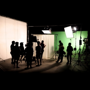 Group of people behind the scenes in a production studio